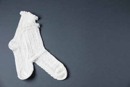 Pair of comfortable white socks on gray background, top view. Space for textの写真素材