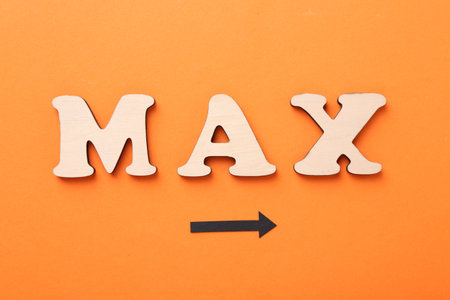 Word Max made of wooden letters and arrow on orange background, flat layの写真素材