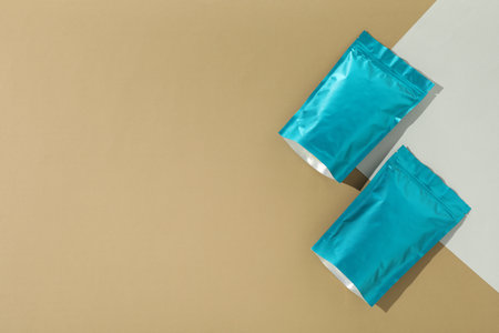 Zipper stand-up pouches on color background, flat lay. Mockup for designの写真素材