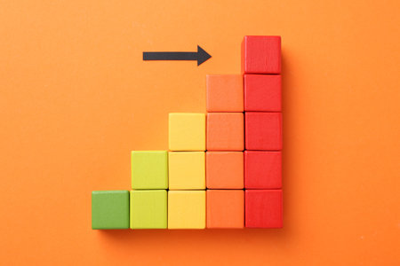 Maximum. Arrow pointing at colorful cubes on orange background, top view