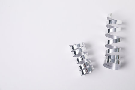 Shiny party streamers on white background, top view. Space for textの写真素材