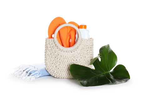 Stylish bag with beach accessories isolated on whiteの写真素材
