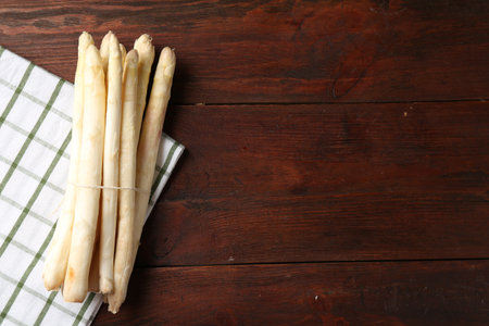 Raw asparagus spears on wooden table, top view. Space for textの写真素材