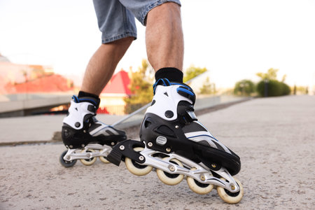 Man roller skating on city street, closeup