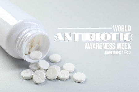 World antibiotic awareness week. Bottle and scattered pills on light backgroundの写真素材
