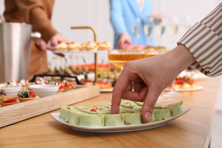 People with different appetizers at buffet, selective focusの写真素材