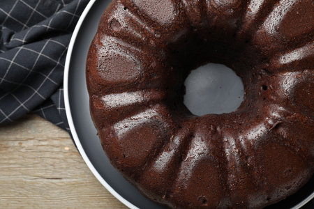 Tasty chocolate bundt cake on wooden table, top viewの写真素材
