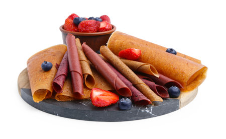 Delicious fruit leather rolls and berries isolated on whiteの写真素材