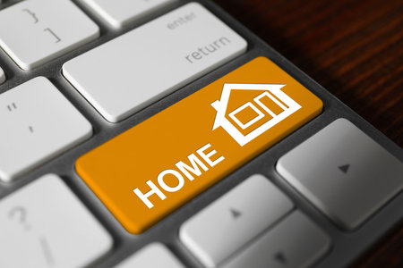 Online accommodation search. Button with house icon and word Home on computer keyboard, closeupの写真素材