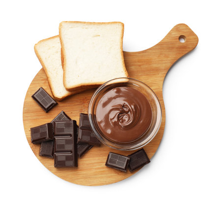 Tasty chocolate butter in glass bowl, pieces of chocolate and slices of bread isolated on white, top viewの写真素材