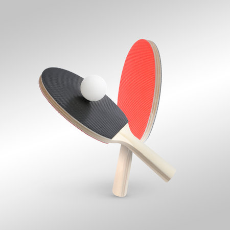 Ping pong rackets and ball in air against light gray backgroundの写真素材