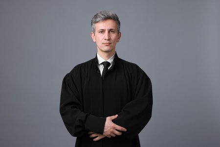 Portrait of judge in court dress on grey backgroundの写真素材