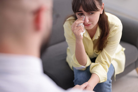 Psychologist supporting patient during therapy session in office, closeup