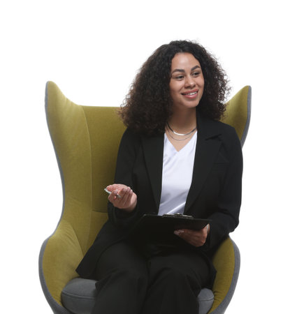 Professional psychologist with clipboard and pen in armchair on white backgroundの写真素材
