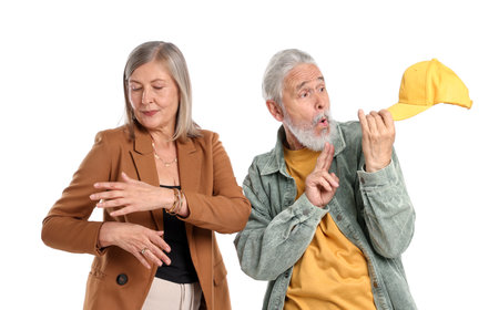 Senior couple in stylish outfits on white backgroundの写真素材
