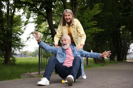 Lovely senior couple having fun together in parkの写真素材