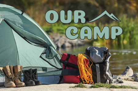 Our camp, summer vacation. Tent and tourist equipment near river in natureの写真素材
