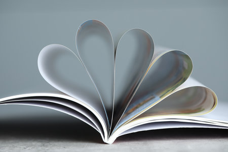 One open magazine on gray table, closeupの写真素材