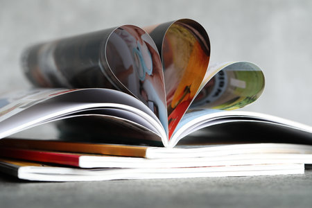 Stack of different magazines on gray table, closeupの写真素材