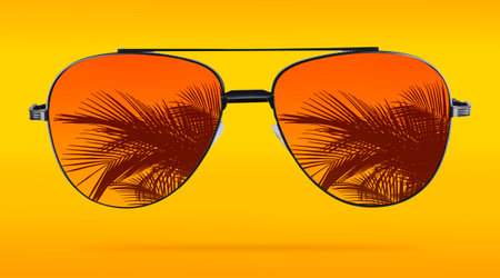 Bright sunglasses with reflection of palm on lenses against orange gradient backgroundの写真素材
