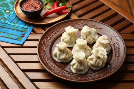 Delicious khinkali served on wooden table, above view