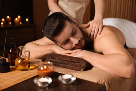 Man receiving relaxing massage in spa salonの写真素材