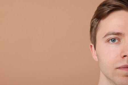 Man after shaving on beige background, closeup. Space for textの写真素材