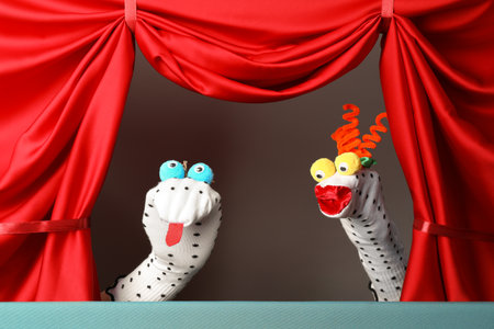 Creative puppet show on stage with red curtainsの写真素材