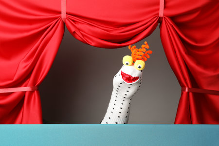 Creative puppet show on stage with red curtainsの写真素材