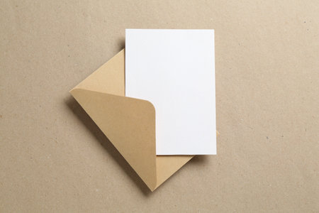 Blank invitation card and envelope on carton, top view. Space for designの写真素材