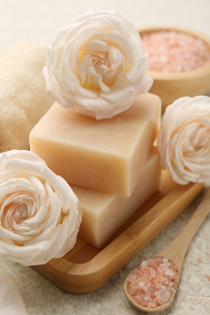 Soap bars, sea salt and flowers on white textured table, closeupの写真素材