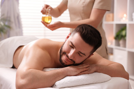 Man receiving relaxing massage in spa salonの写真素材