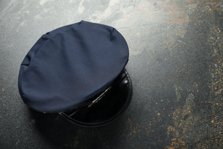 Police cap on dark table, top view. Space for textの写真素材
