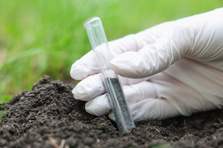Scientist soil taking sample for research outdoors, closeup
