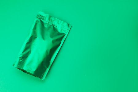 Zipper stand-up pouch on green background. Mockup for designの写真素材