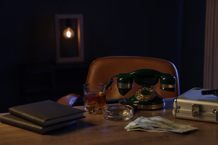 Money, whiskey and other stuff on wooden table in mafia boss officeの写真素材