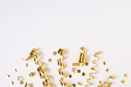 Shiny party streamers and confetti on white background, flat lay. Space for textの写真素材