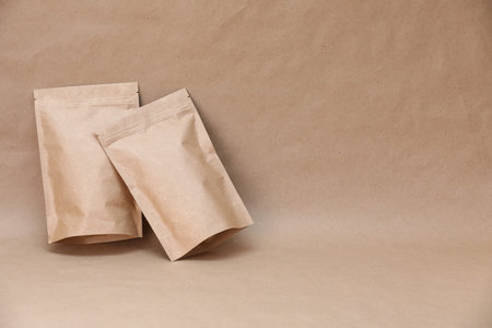 Zipper stand-up pouches on kraft paper background. Mockup for design