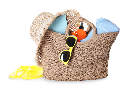 Stylish bag with beach accessories isolated on whiteの写真素材