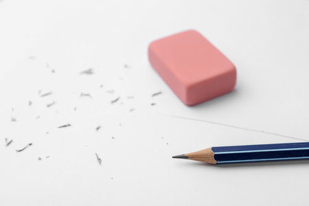 Graphite pencil and eraser on paper sheet, closeupの写真素材