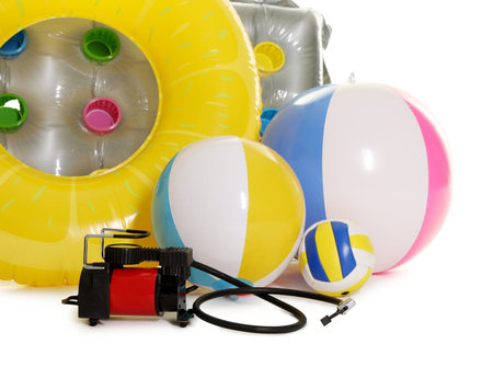 Inflatable ring, mattress, balls and air compressor isolated on white