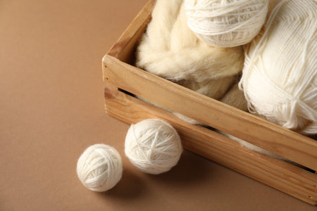 Felting wool and knitting yarn on brown background, closeupの写真素材