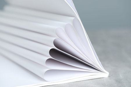 One open magazine on gray table, closeup
