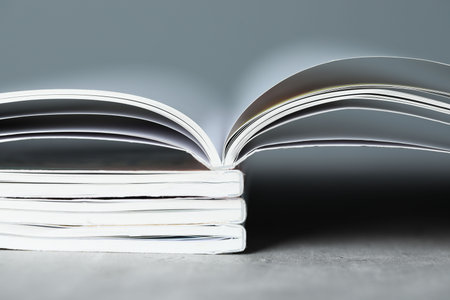 Stack of different magazines on gray table, closeupの写真素材