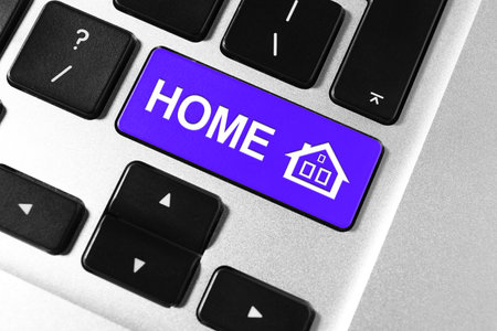 Online accommodation search. Button with house icon and word Home on computer keyboard, closeupの写真素材