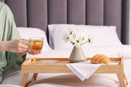 Woman having delicious breakfast in bed, closeupの写真素材
