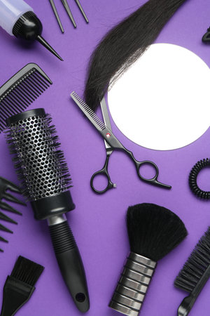 Different hairdresser's tools on purple background, flat layの写真素材