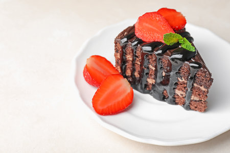 Piece of chocolate cake served with strawberries on white table, closeup. Space for textの写真素材