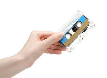 Woman holding audio cassette with blank label on white background, closeupの写真素材