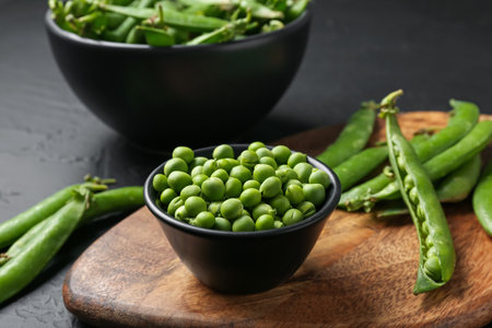 Fresh ripe green peas on black table, closeupの写真素材